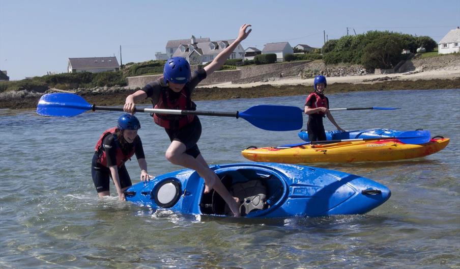 young people having fun in kayaks, Rhoscolyn