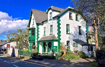 The white and green exterior of Crafnant House, a B&B in Trefriw, Snowdonia, North Wales