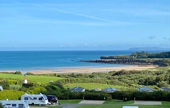 Spacious all-weather serviced pitches for tents, touring caravans, campervans and motorhomes with stunning sea-views of Lligwy Bay on Anglesey.