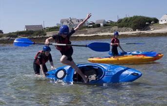 young people having fun in kayaks, Rhoscolyn