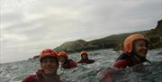 Family fun in the sea off Anglesey on our amazing Coasteering route.