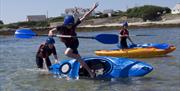 young people having fun in kayaks, Rhoscolyn